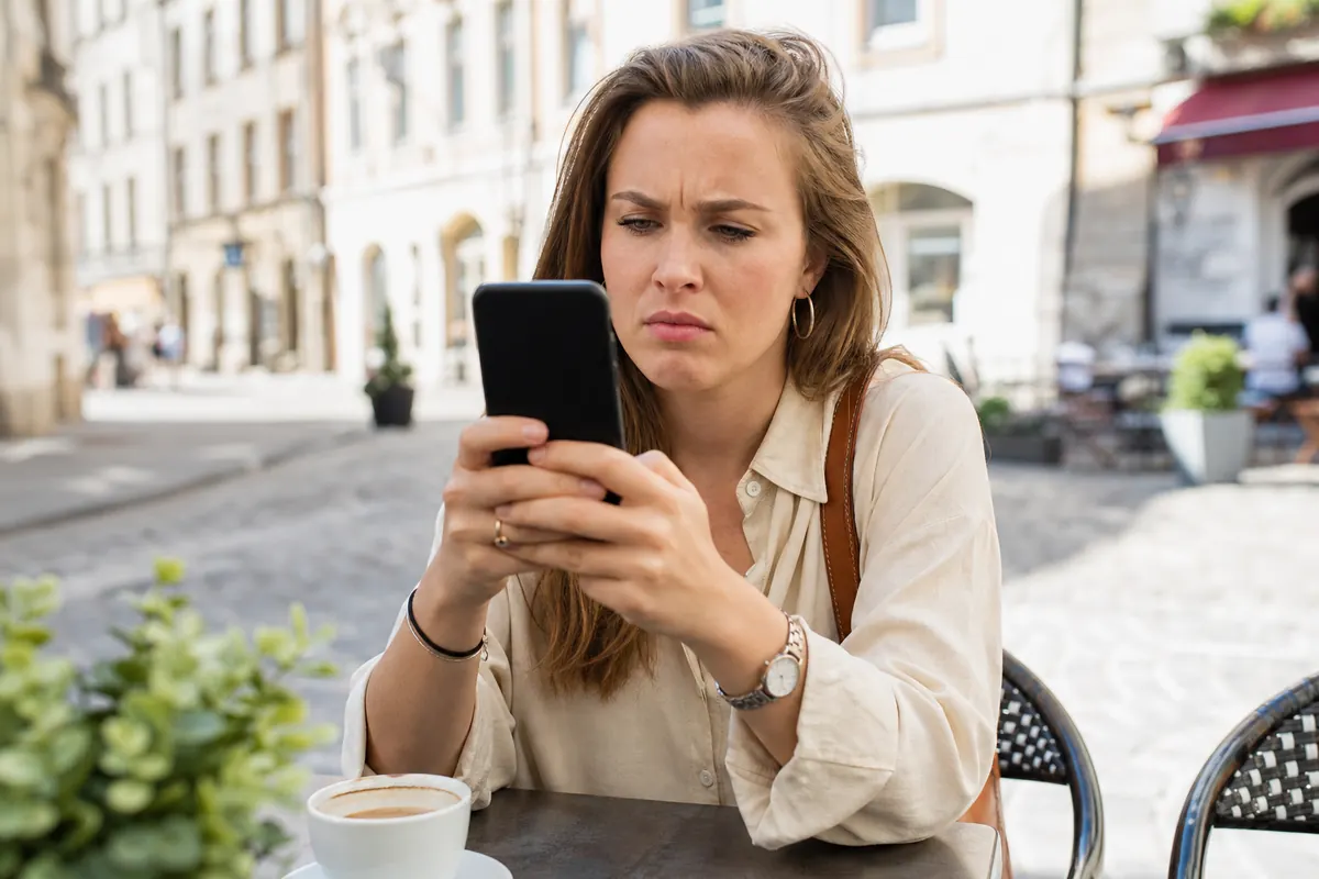 Traveler adjusting network settings on their smartphone abroad.