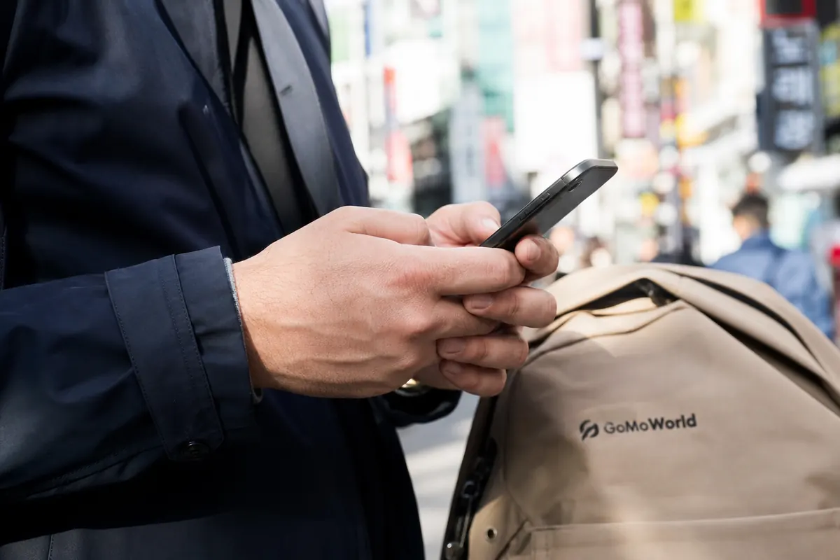 Female traveler activating her internet data plan on her smartphone in South Korea.